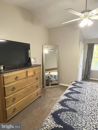 a bedroom with a large bed and a window