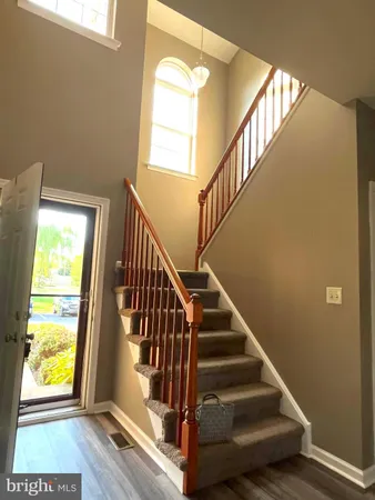 a view of entryway and hall with wooden floor