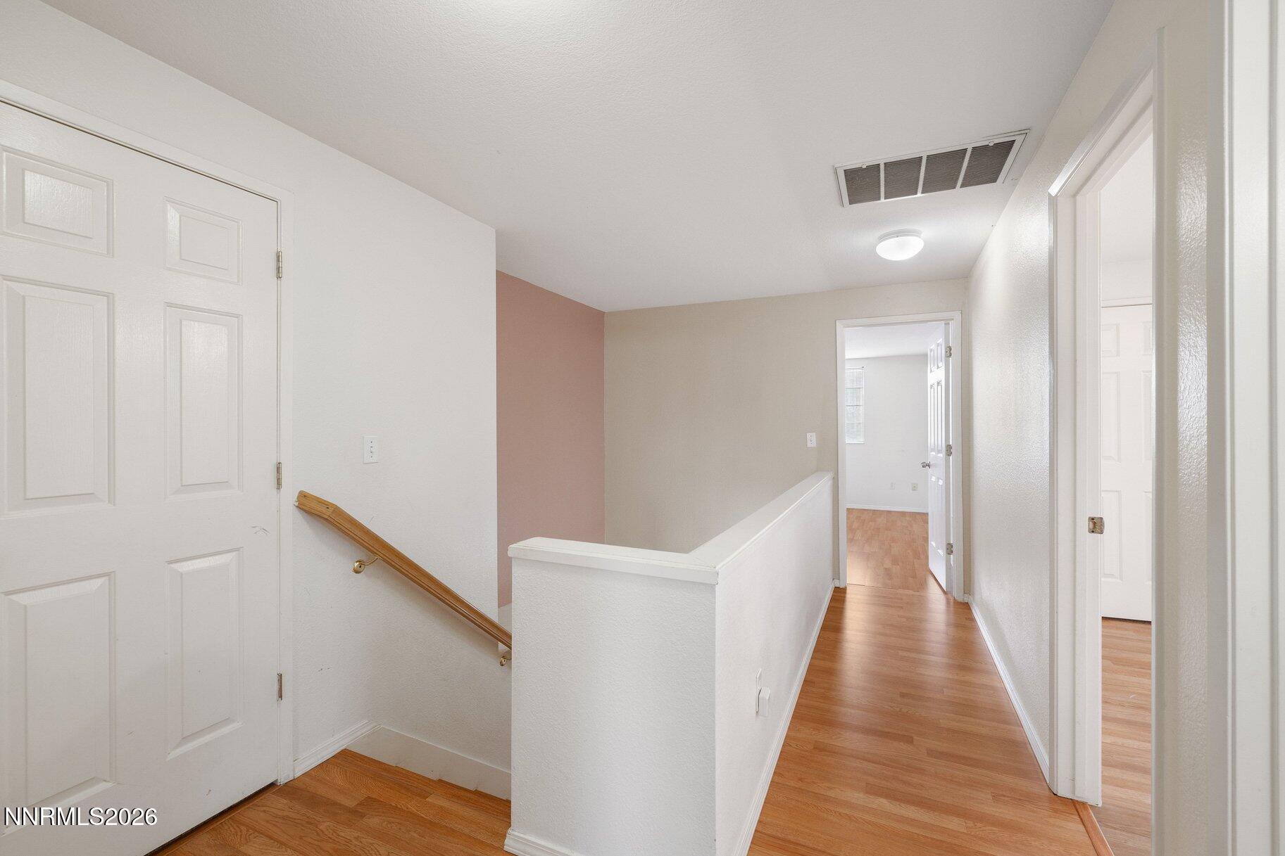 8486 Piper Place Reno, NV 89506 - Photo 16 of 80 a view of a hallway with wooden floor and entryway