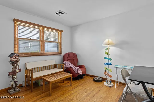 a living room with furniture a flat screen tv and a window