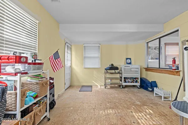 a bedroom with furniture and a window