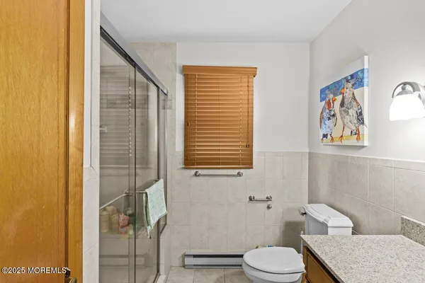 a bathroom with a toilet sink and shower