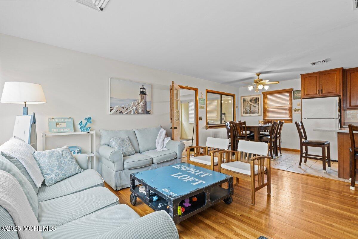 100 3rd Avenue Lavallette, NJ 08735 - Photo 2 of 39 a living room with furniture a wooden floor and a table