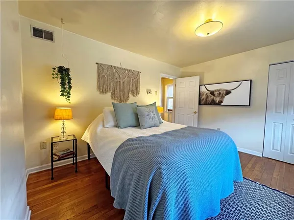 a bedroom with a bed and lamps