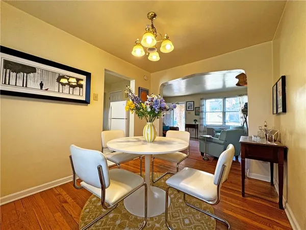 a view of a dining room with furniture and a chandelier
