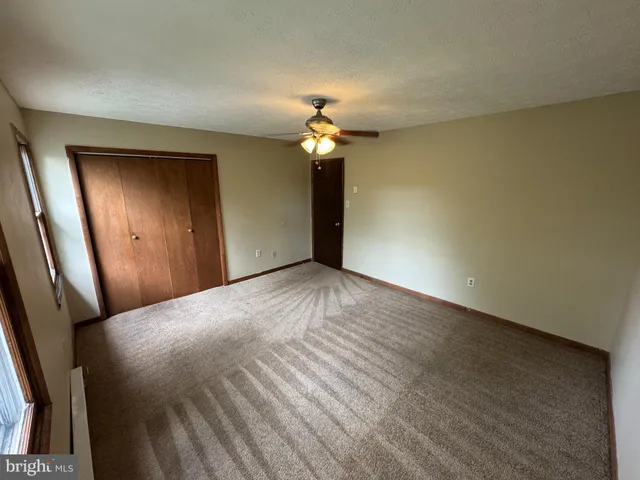 a view of empty room with a chandelier fan