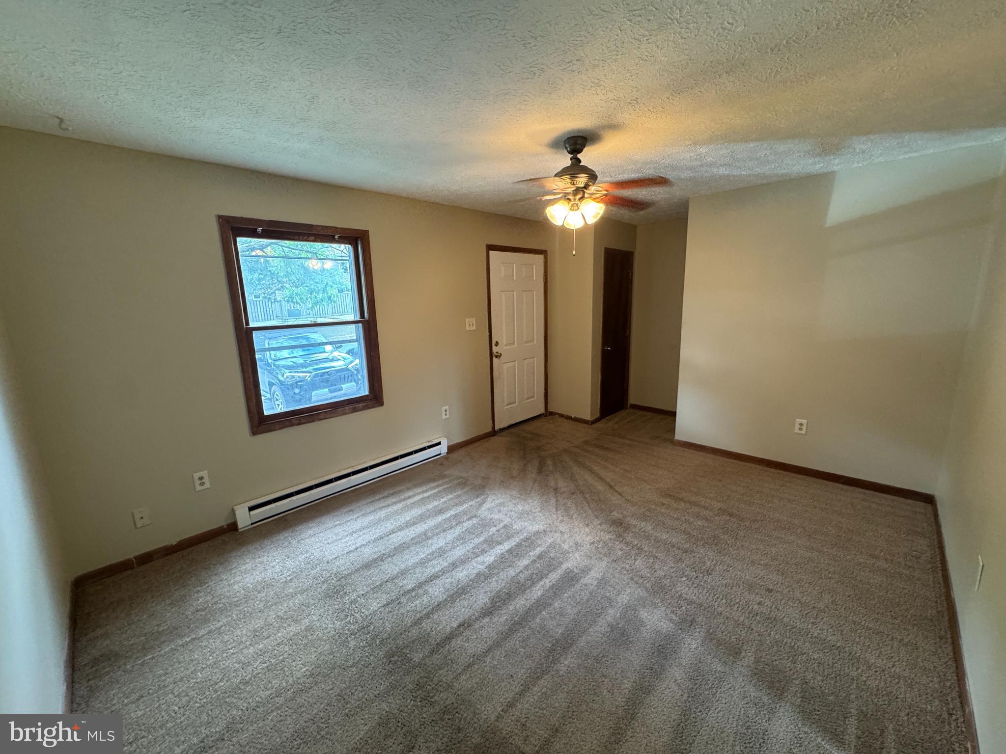 512 Allston Circle Winchester, VA 22601 - Photo 3 of 15 an empty room with a chandelier fan and windows