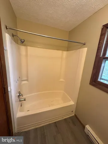 a bathroom with a bathtub and a shower