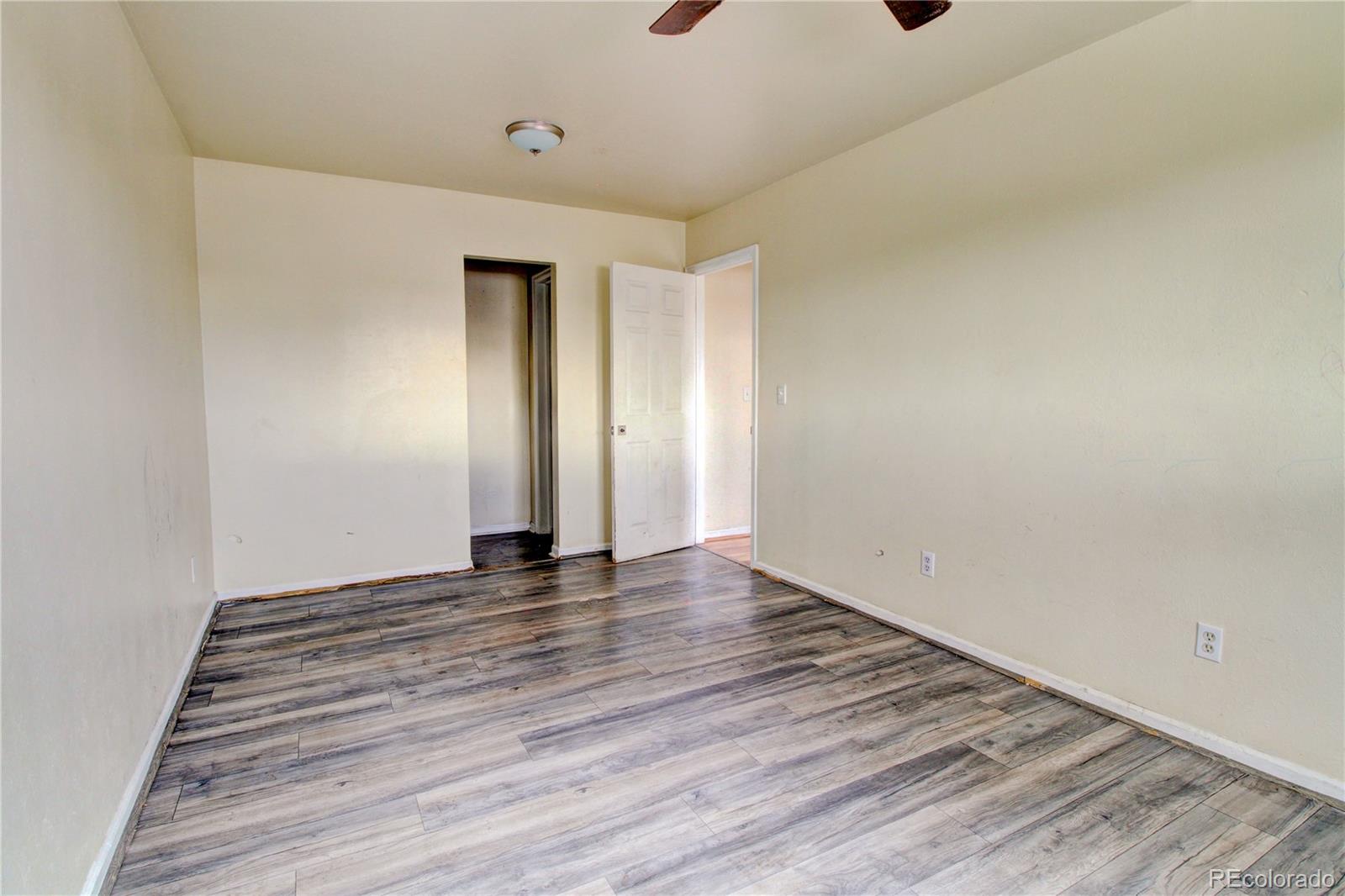 9340 West 49th Avenue, Unit 213 Wheat Ridge, CO 80033 - Photo 11 of 16 a view of an empty room with wooden floor