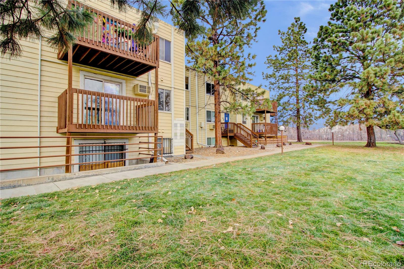 9340 West 49th Avenue, Unit 213 Wheat Ridge, CO 80033 - Photo 16 of 16 a view of a house with a yard