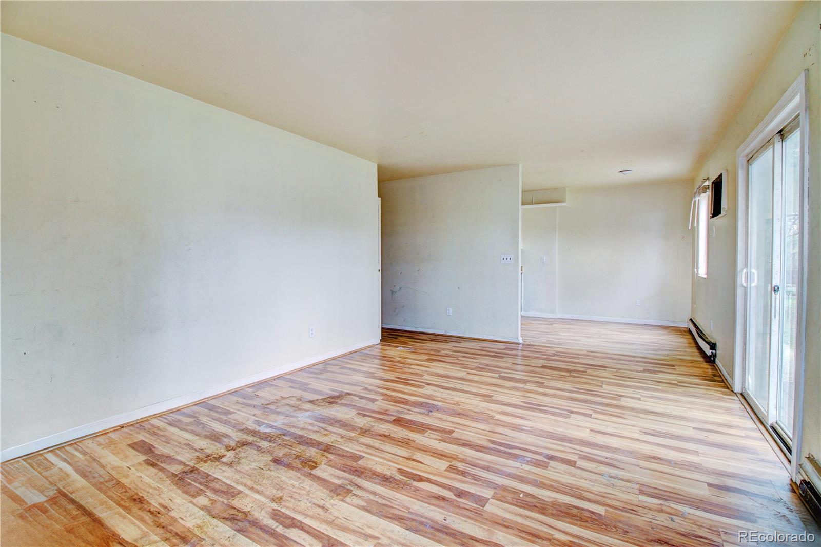 9340 West 49th Avenue, Unit 213 Wheat Ridge, CO 80033 - Photo 4 of 16 a view of empty room with wooden floor