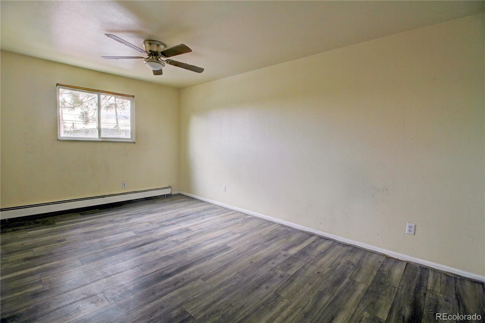 9340 West 49th Avenue, Unit 213 Wheat Ridge, CO 80033 - Photo 10 of 16 a view of a room with wooden floor and fan