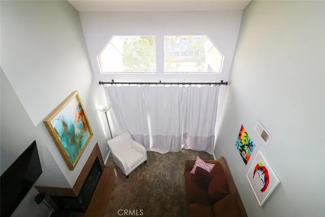 a living room with a baby crib furniture and a window