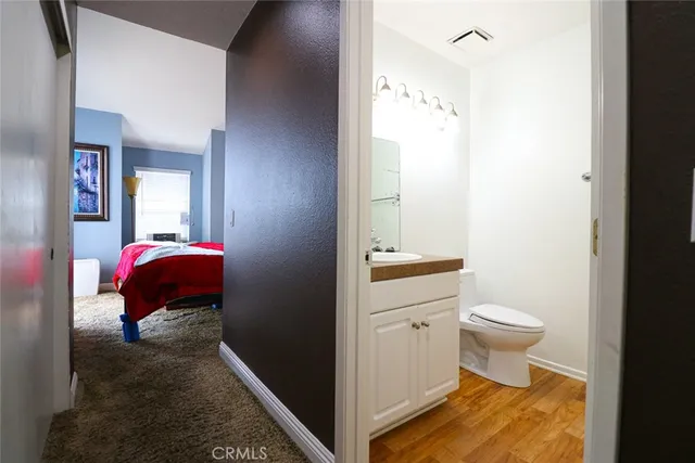a bathroom with a sink a toilet and mirror
