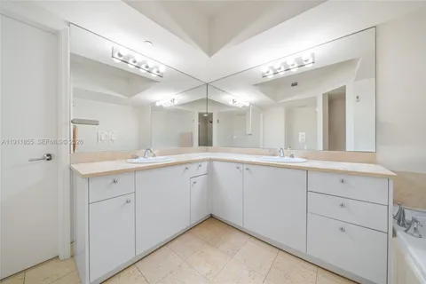 a spacious bathroom with a double vanity sink mirror and