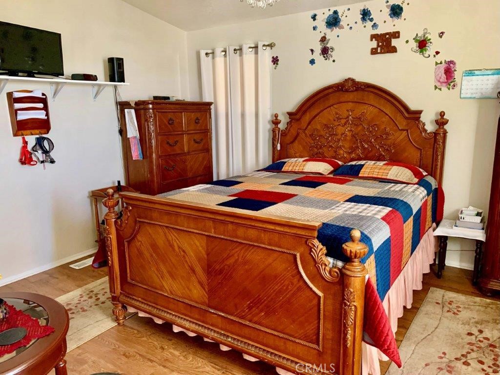 33600 Calimesa Boulevard, Unit 141 Yucaipa, CA 92399 - Photo 11 of 23 a bedroom with a bed and dresser