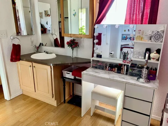 a kitchen with a sink cabinets and wooden floor
