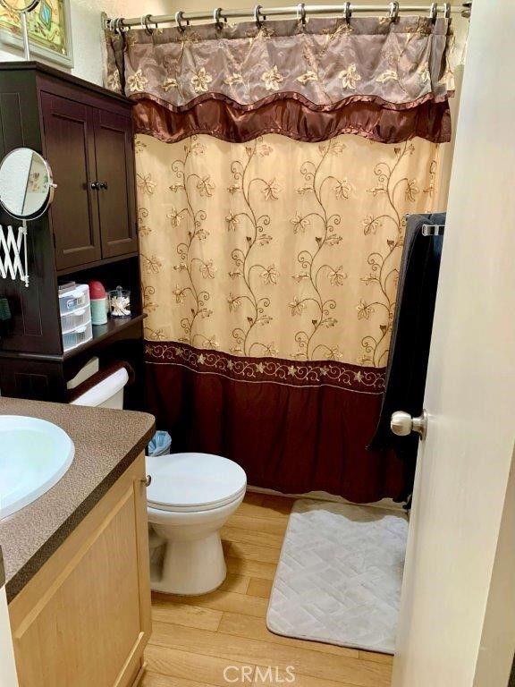 33600 Calimesa Boulevard, Unit 141 Yucaipa, CA 92399 - Photo 18 of 23 a bathroom with a granite countertop toilet and a sink