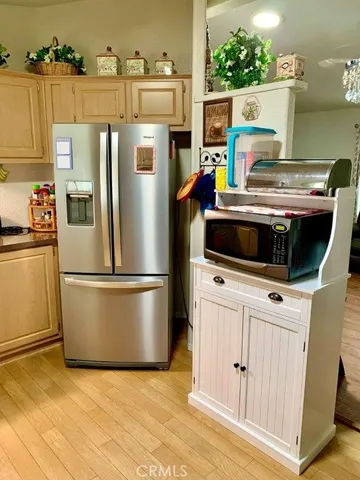a white refrigerator freezer and a stove sitting inside of a kitchen