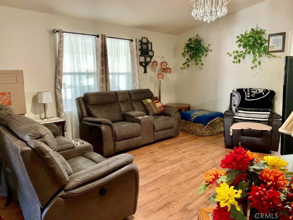 33600 Calimesa Boulevard, Unit 141 Yucaipa, CA 92399 - Photo 7 of 23 a living room with furniture and flowers