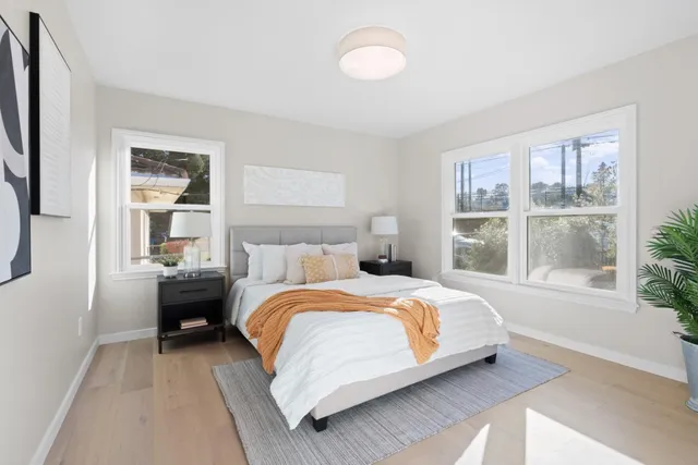 a bedroom with a bed and a large window