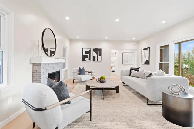 a living room with furniture and a fireplace