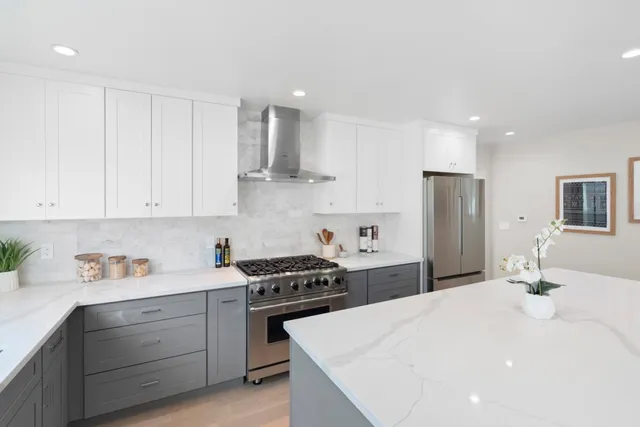 a kitchen with a white cabinets and refrigerator