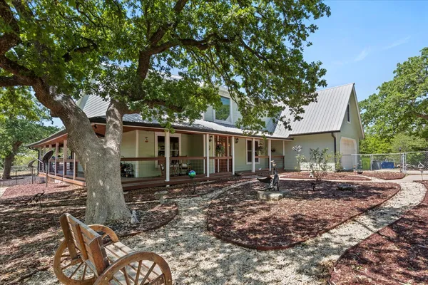 a view of a house with backyard porch and sitting area