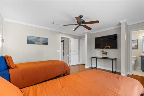 a bedroom with two beds and a flat screen tv