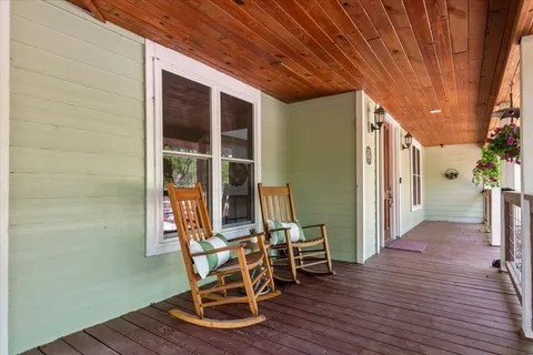 a view of a room with wooden floor and outdoor seating
