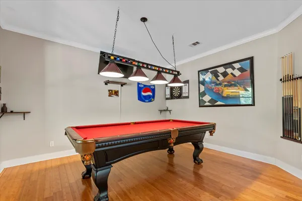a room with pool table and windows