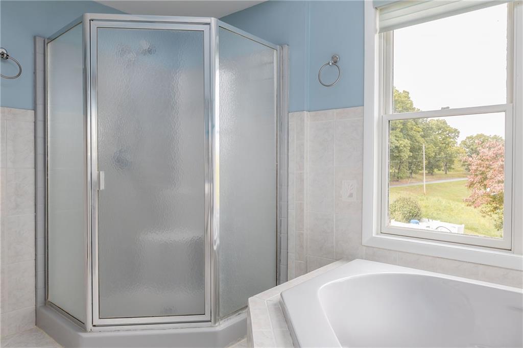 292 Blaker Ridge Road Waynesburg, PA 15370 - Photo 13 of 25 a bathroom with a bathtub and a shower