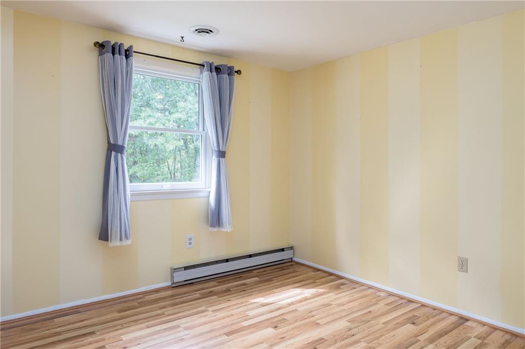 292 Blaker Ridge Road Waynesburg, PA 15370 - Photo 15 of 25 a view of an empty room with wooden floor and a window