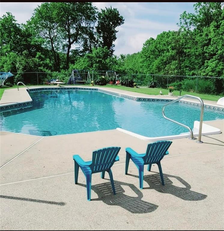 292 Blaker Ridge Road Waynesburg, PA 15370 - Photo 22 of 25 a view of a lake with a table and chairs