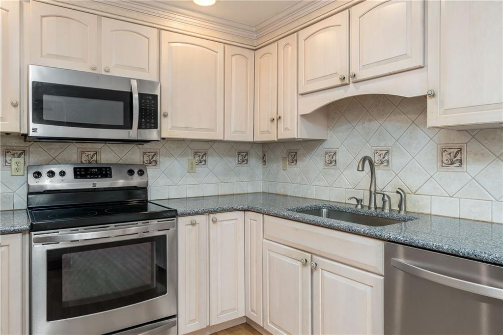 292 Blaker Ridge Road Waynesburg, PA 15370 - Photo 5 of 25 a kitchen with white cabinets and black appliances