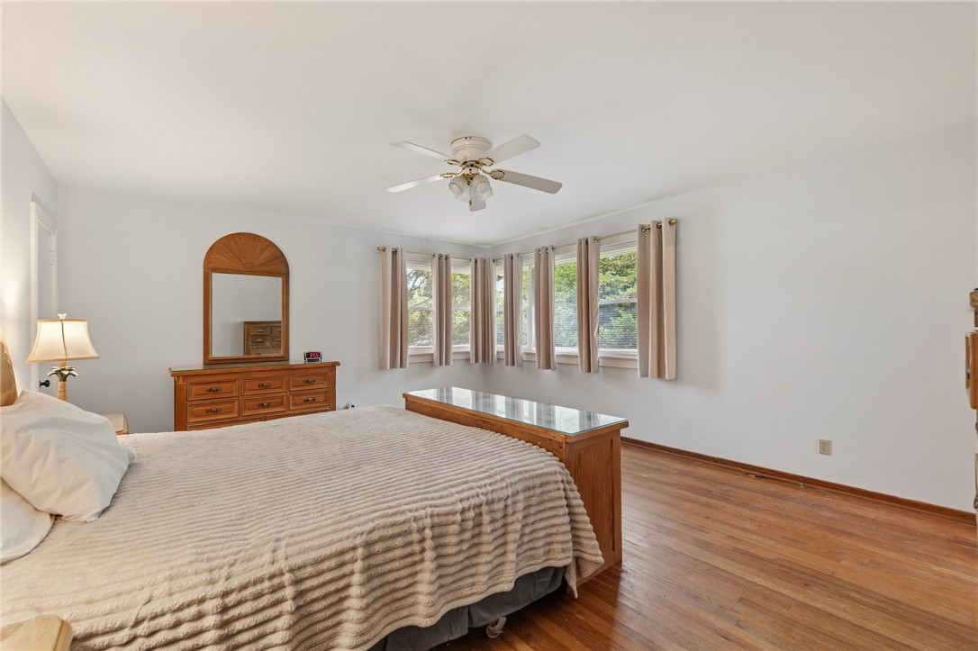 1105 Greenacres Anderson, SC 29621 - Photo 20 of 46 Hardwood flooring and multiple windows create a bright, inviting bedroom retreat.