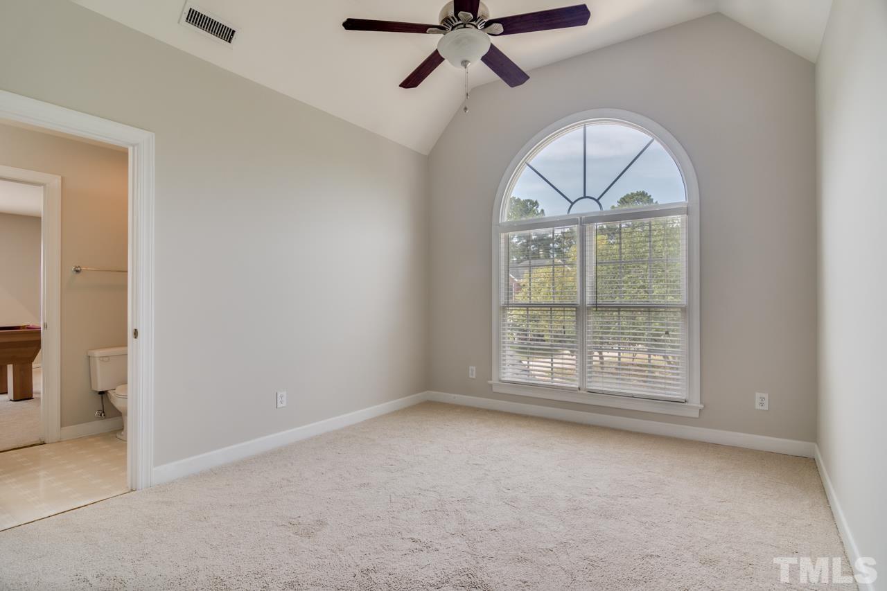 8208 Manatee Court Raleigh, NC 27616 - Photo 15 of 30 an empty room with a ceiling fan and window