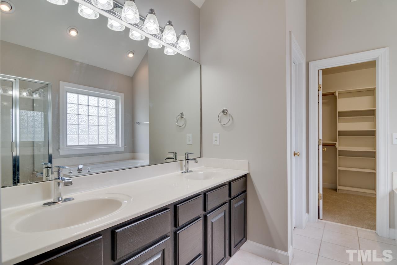 8208 Manatee Court Raleigh, NC 27616 - Photo 20 of 30 a bathroom with a sink double vanity and a mirror