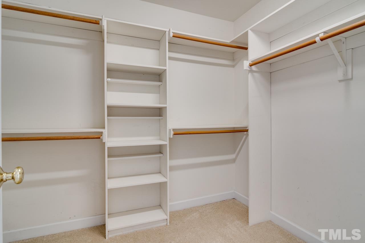 8208 Manatee Court Raleigh, NC 27616 - Photo 21 of 30 a view of walk in closet with empty racks