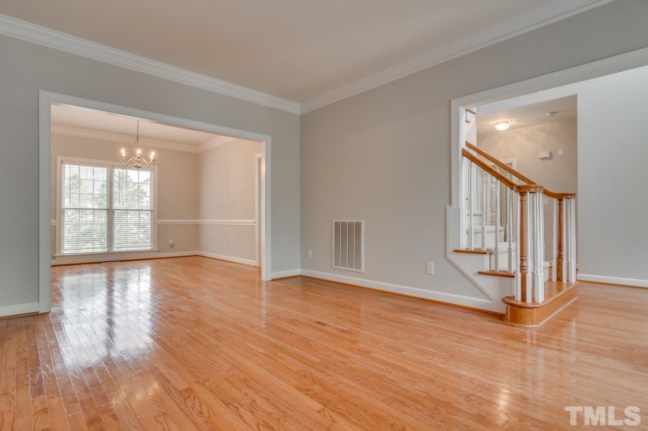 8208 Manatee Court Raleigh, NC 27616 - Photo 3 of 30 a view of an empty room with wooden floor and a window