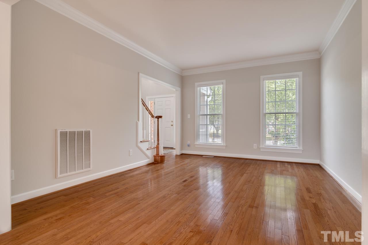 8208 Manatee Court Raleigh, NC 27616 - Photo 4 of 30 a view of an empty room with wooden floor and window