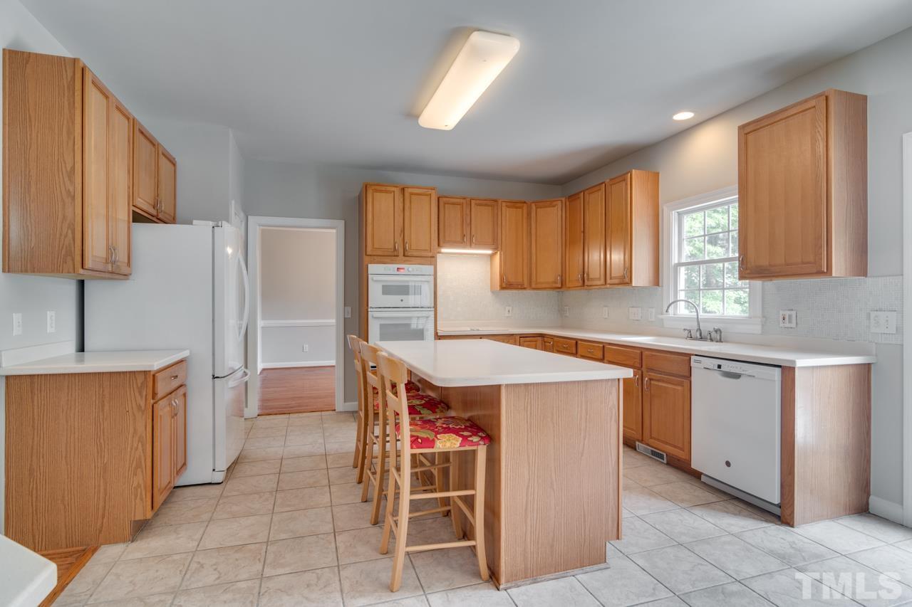 8208 Manatee Court Raleigh, NC 27616 - Photo 6 of 30 a kitchen with a stove a refrigerator and a sink
