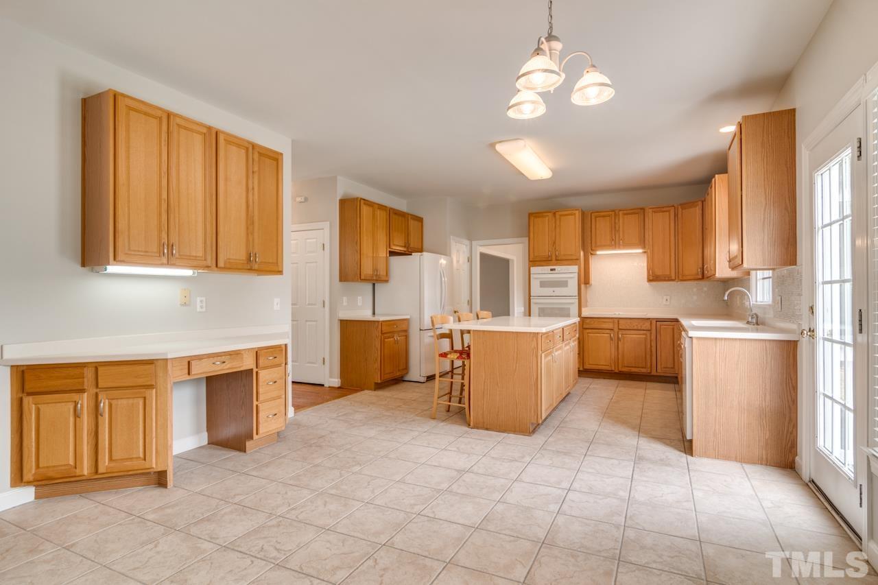 8208 Manatee Court Raleigh, NC 27616 - Photo 7 of 30 a large kitchen with cabinets and furniture