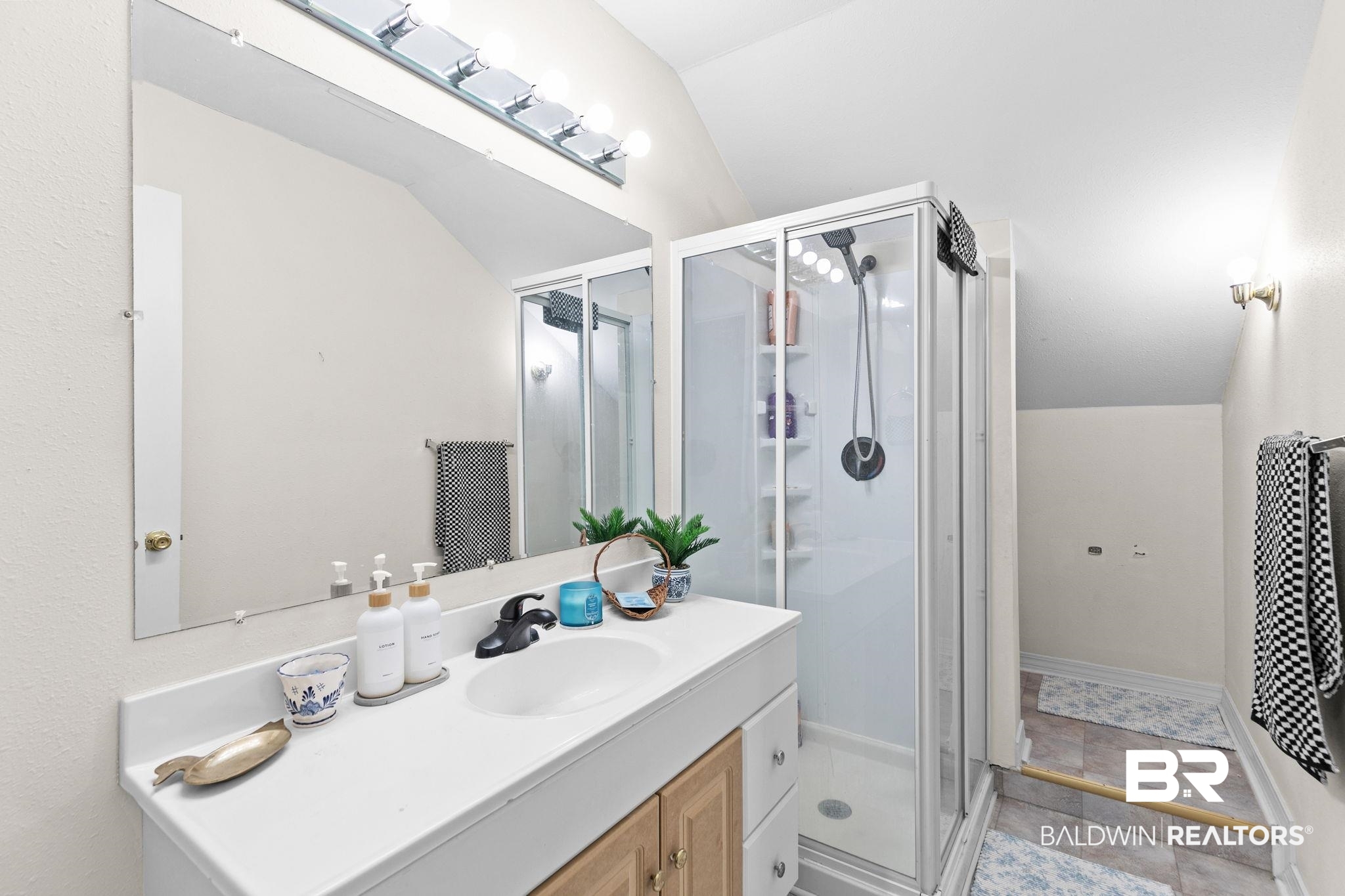 3842 Experiment Farm Road Monroeville, AL 36460 - Photo 53 of 59 Full bathroom with lofted ceiling, vanity, and a stall shower