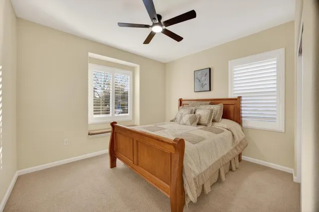 a spacious bedroom with a bed and a large window