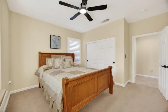 a bedroom with a large bed and a flat screen tv