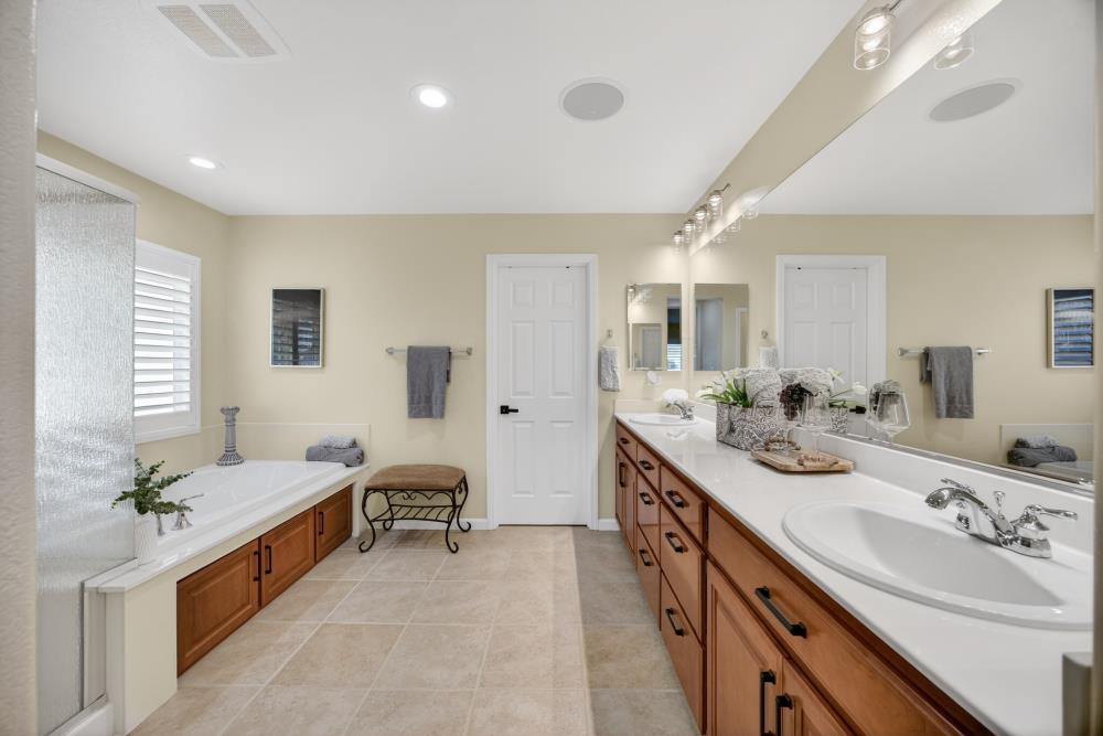 3670 Topaz Road West Sacramento, CA 95691 - Photo 22 of 97 a large bathroom with a double vanity sink a large mirror and a bathtub