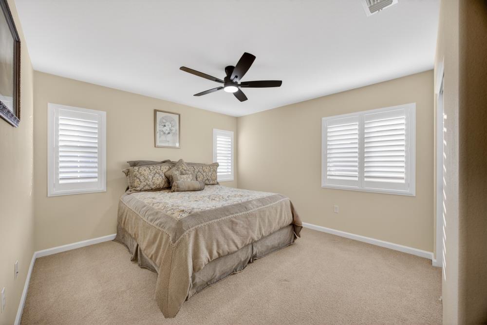 3670 Topaz Road West Sacramento, CA 95691 - Photo 29 of 97 a spacious bedroom with a bed and a ceiling fan