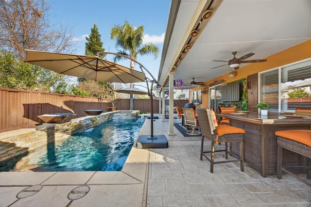 a living room with couches and a potted plant