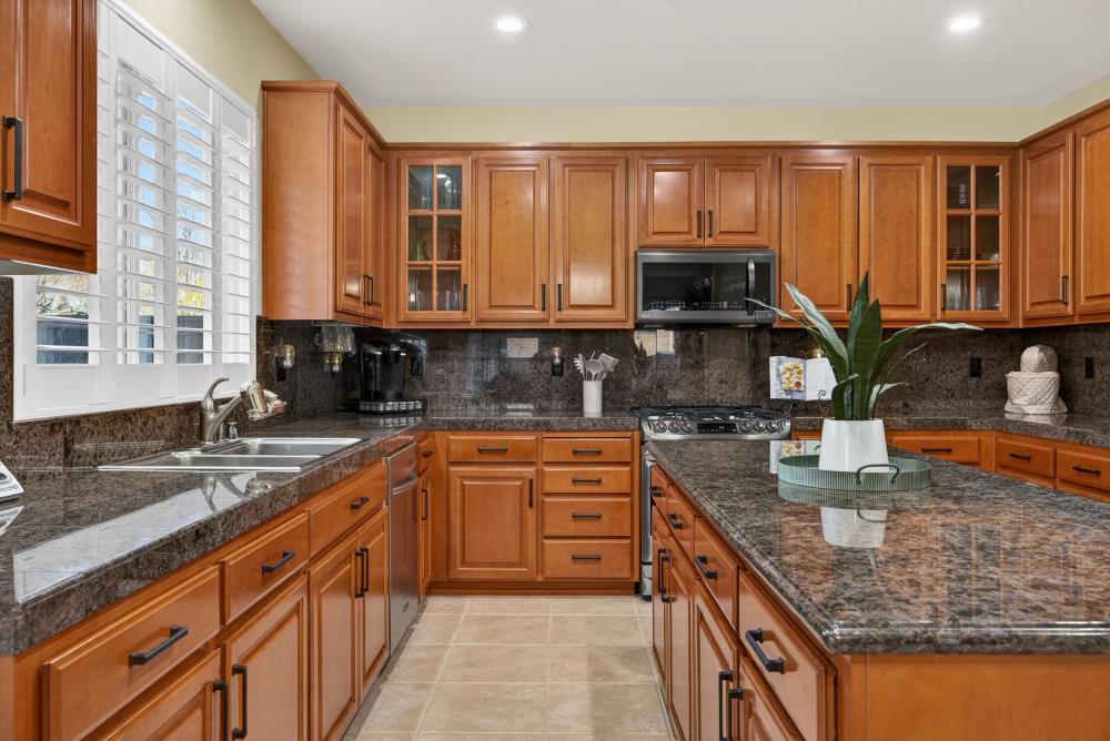 3670 Topaz Road West Sacramento, CA 95691 - Photo 74 of 97 a kitchen with stainless steel appliances granite countertop a stove a sink and a microwave